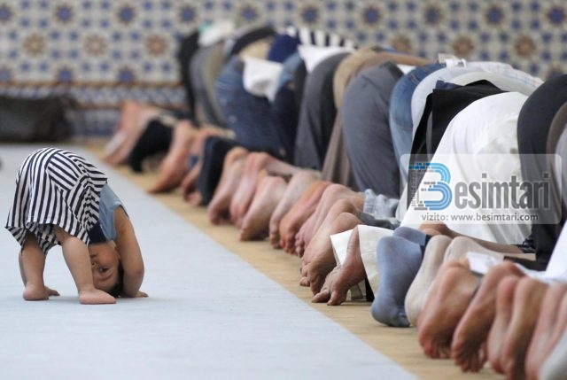 A child is seen near members of the Muslim community attending midday prayers at Strasbourg Grand Mosque in Strasbourg